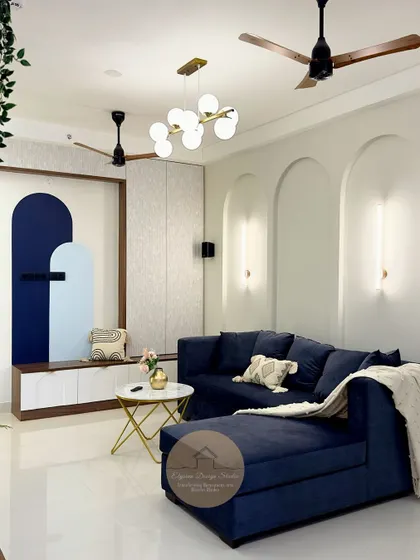 The entryway and living area at Candeur Signature, Bangalore, went from a blank canvas to a stylish and welcoming space. We introduced a bold blue sofa, custom wall niches with arch details, and modern lighting to create a home with personality and comfort.