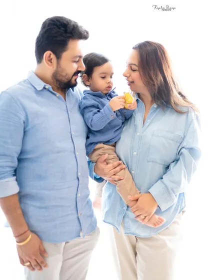 A happy family moment during a bunny-themed photoshoot. Including parents in the fun makes the experience more memorable for everyone.
