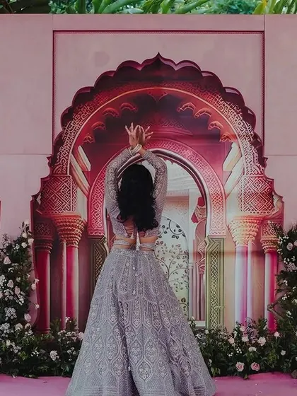Amidst the grandeur of the Rajput palace-themed stage, the couple shares a playful dance. These are the candid, joyful moments that make a wedding celebration truly special.