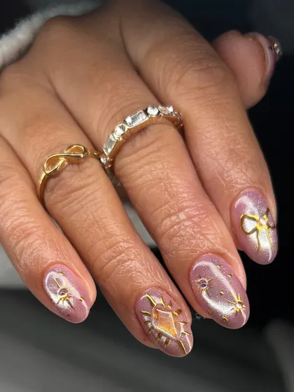 This shot highlights the variety of hand-painted gold designs in this set, including a radiant sun and a delicate bow.