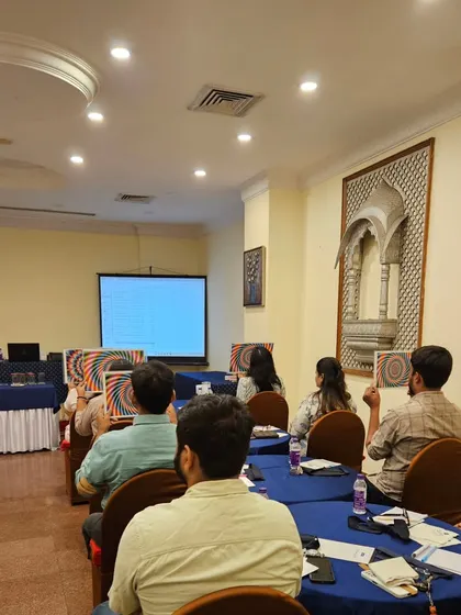 Participants at my workshop holding up charts used for a focus and concentration exercise. These practical tools help in activating the Ajna chakra.