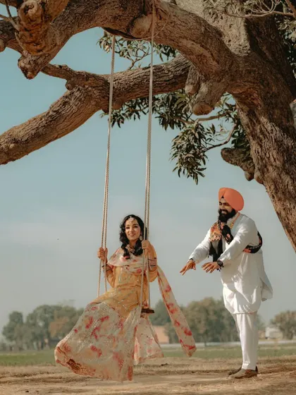 A joyful moment on a tree swing, a classic symbol of romance in a rustic, natural setting.