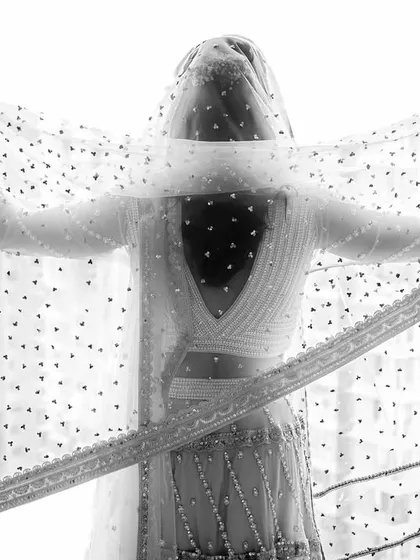 A powerful and symbolic black and white portrait. The bride spreads her veil like wings, a beautiful representation of her strength and spirit.