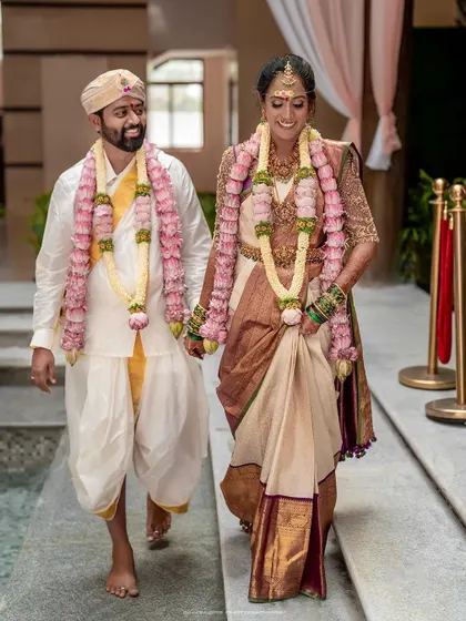 The joyful walk after the ceremony. The couple's happy expressions and linked hands tell a story of celebration and new beginnings.