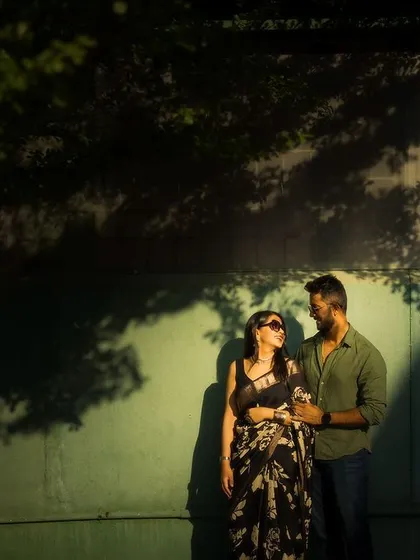 A couple enjoying a quiet moment, highlighted by a patch of golden hour sunlight against a wall. I love finding these pockets of beautiful light to create unique and artistic compositions.