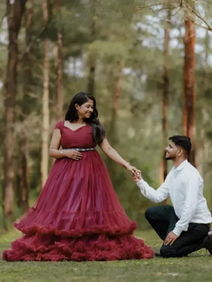A classic romantic pose for a pre-wedding shoot. The gentleman kneels for his bride to be, who looks stunning in our tiered magenta gown.