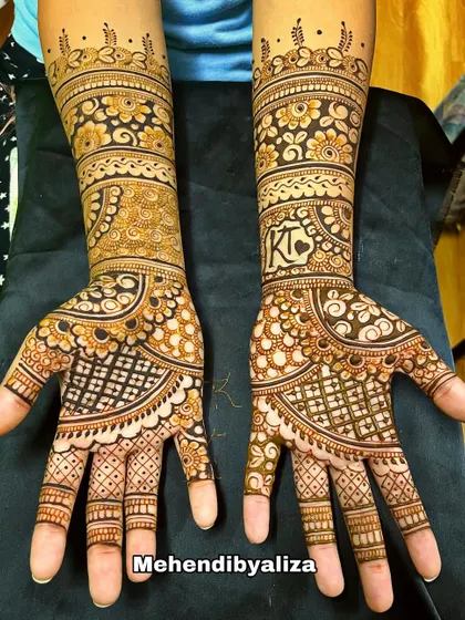 A gorgeous engagement henna design with initials, floral bands, and checkered patterns. This is a perfect example of a full, yet not overly dense, design.