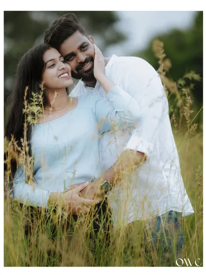 An intimate embrace in a field of tall grass, this pre-wedding photo is filled with warmth and affection.