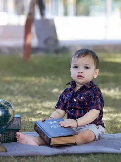 The 'Curious Explorer' theme is perfect for inquisitive little minds. With props like a globe, vintage books, and a telescope, we can create a world of adventure for your child's photoshoot.