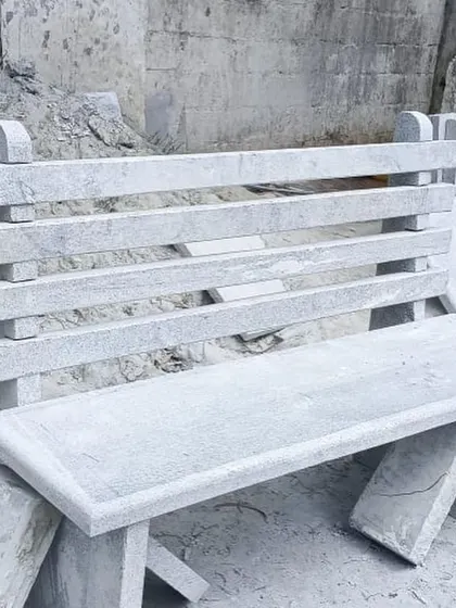 A classic park-style bench with a four-slat backrest, made from solid Bangalore stone.