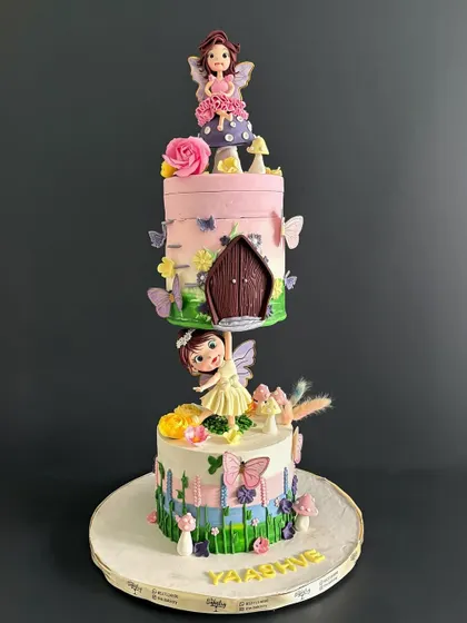This gravity-defying fairy cake is a true showstopper. I designed it to look like one fairy is holding up an entire tier, creating a magical illusion.