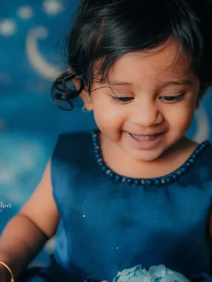 That happy little smile is everything. Celebrating a first birthday is a magical milestone, and this photo captures that joy perfectly.