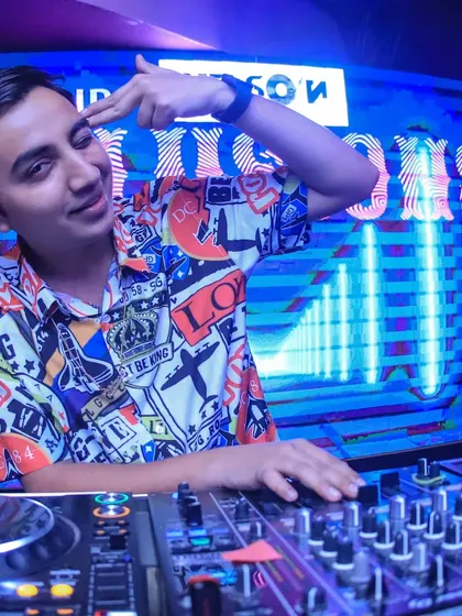 A fun, interactive pose behind the decks at Club Illusions. I'm here to have a good time with the crowd, not just play for them.