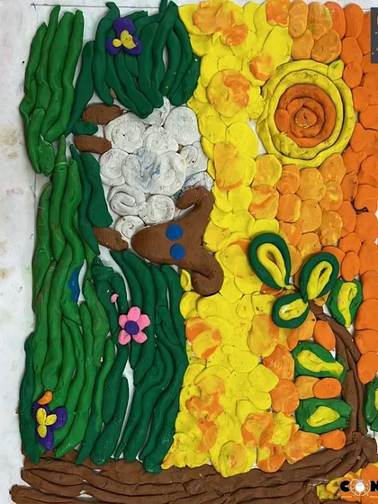A close-up of a vibrant playdough landscape. You can see the different techniques used, from rolling long strands for grass to pressing flat shapes for the sun's rays.