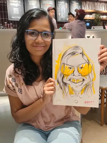 A happy customer at Costa Coffee, thrilled with her personalized caricature.