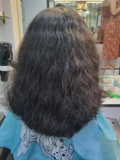 A classic U-cut for this young client. It's a simple yet neat style that helps maintain length while giving the hair a clean, defined shape.