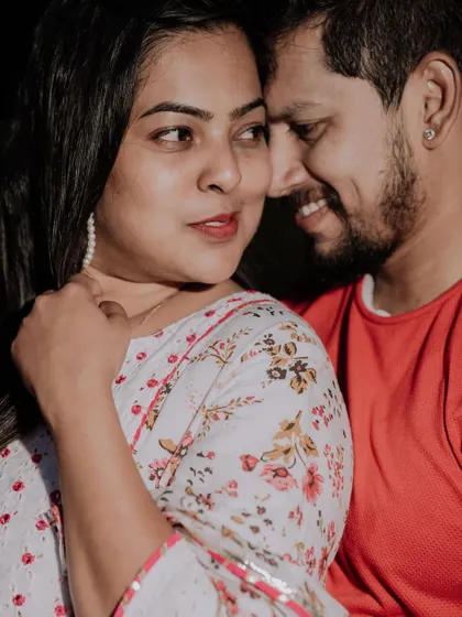A close-up, candid shot capturing a sweet, intimate moment between the couple.