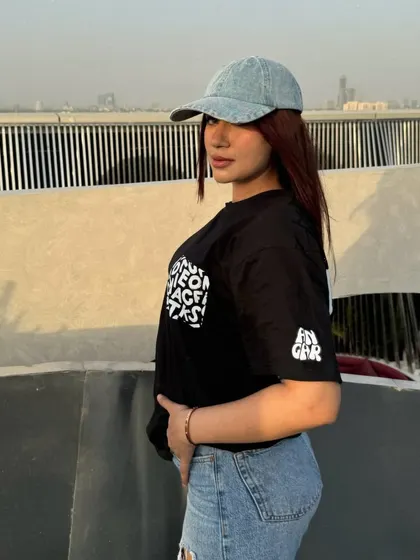 A side profile of the relaxed, oversized tee and jeans look.