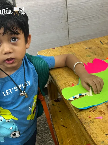 This young artist is adding teeth to his paper dragon. It's so fun to see them bring these mythical creatures to life with their own hands.