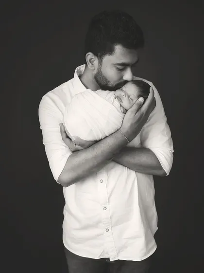 A father's promise, held close. This black and white portrait is a powerful, artistic representation of the bond between a father and his newborn.