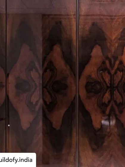 For this wardrobe, we used Burl Veneer from a single bark of wood. The pieces were bookmatched to create this beautiful, symmetrical pattern, showcasing the natural artistry found in the wood grain.