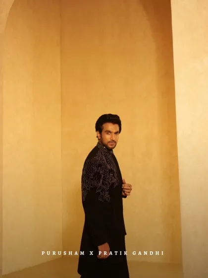 Another angle of Pratik Gandhi, showcasing the intricate embroidery on the back and shoulders of this powerful black jacket.