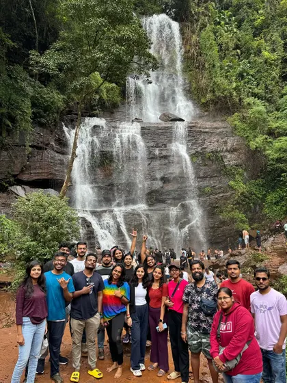 A large group photo in front of a waterfall in Chikmagalur.
