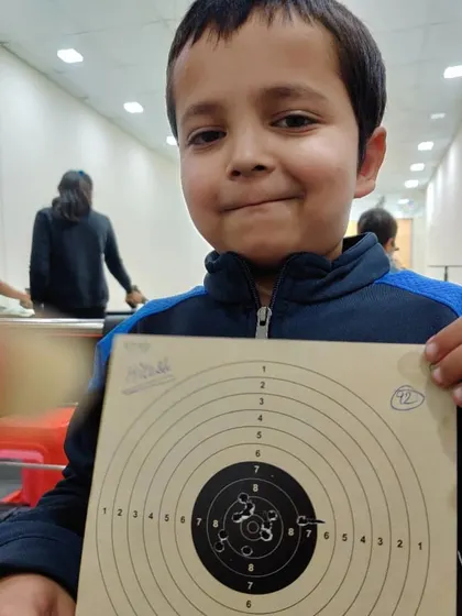 Hitesh, another one of our young talents, proudly showing his target card after a practice session.