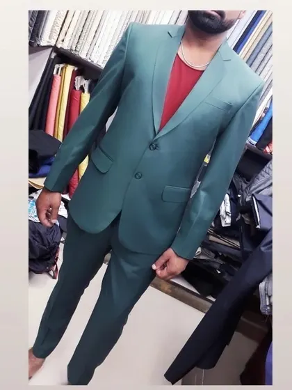 A client trying on his newly tailored green two-piece suit. I ensure a perfect fit that is both comfortable and flattering.
