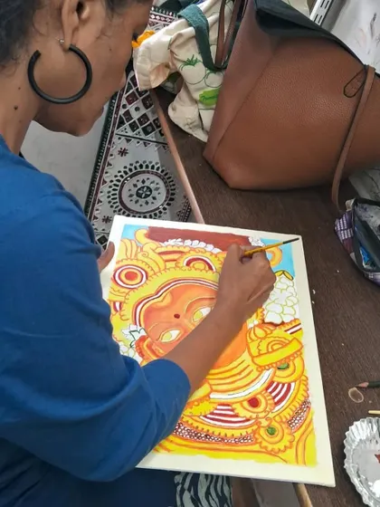 Another shot of a student working on her Kerala mural, showing the concentration and steady hand she has developed through the course.