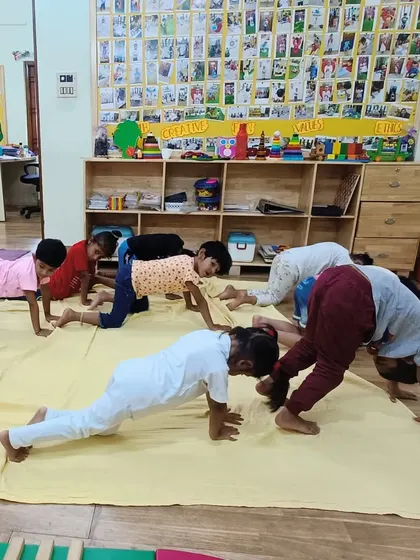 Practicing the Downward-Facing Dog pose together. Yoga at our school is always a group activity filled with encouragement and fun.