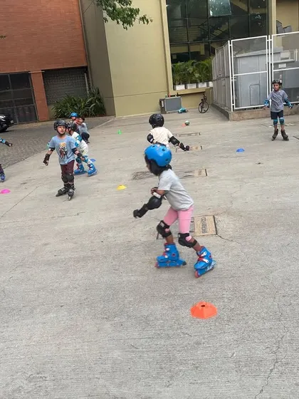 A young skater confidently moves forward, demonstrating the progress made in our classes. We focus on building strong foundational skills so kids can skate with independence.