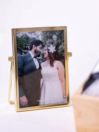 The elegant, freestanding photo frame stands as a beautiful memento for the couple to display in their new home.