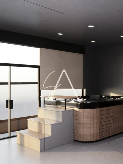 The jacuzzi and sauna area in the wellness center. We used clean lines, a mix of wood and tile, and soft lighting to design a tranquil and luxurious space for relaxation.