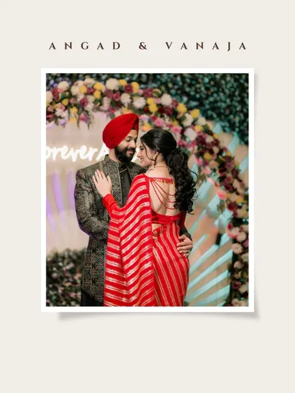A classic portrait of Vanaja and Angad in a loving embrace. The floral arch and "forever" sign in the background perfectly frame this timeless engagement photo.