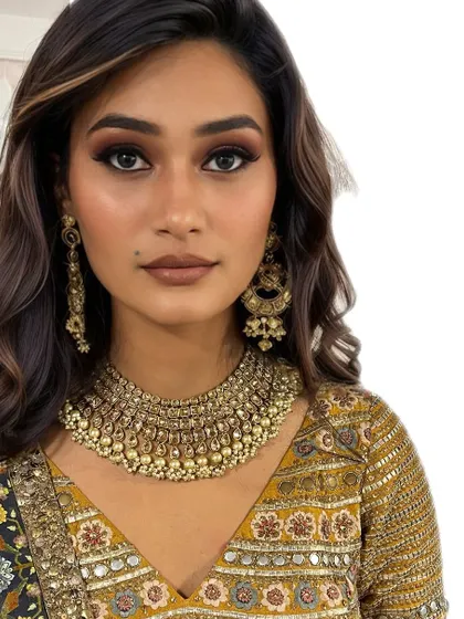This client is ready for her event with soft, glamorous waves and stunning makeup. The hairstyle is designed to complement her features and the intricate details of her outfit.