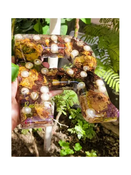 Another angle of the personalized resin monogram, showcasing the glossy finish and the careful arrangement of flowers and pearls.