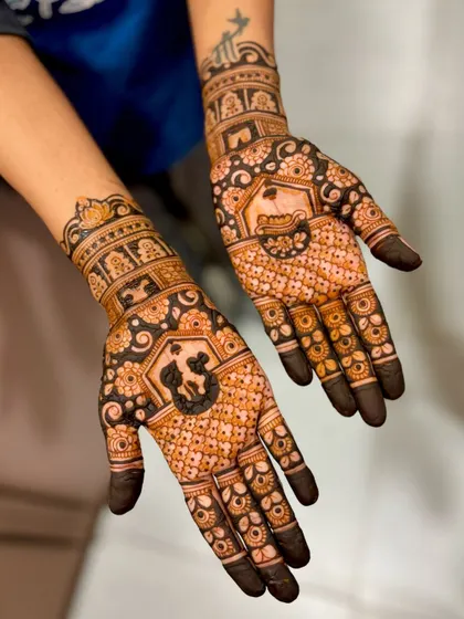 An angled shot of Kratika's mehendi, highlighting the details on the wrist and back of the hand.