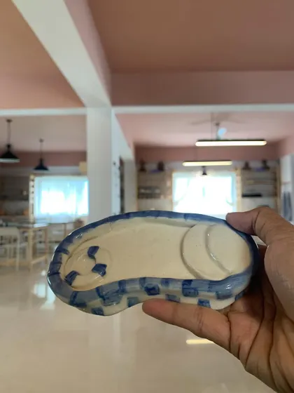 A hand-painted trinket dish in the shape of a swimming pool. Such a playful and creative idea from one of our students.