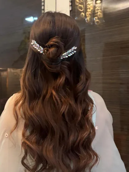Another angle of the half-up bun, showing the texture of the waves and the shine of the hair.
