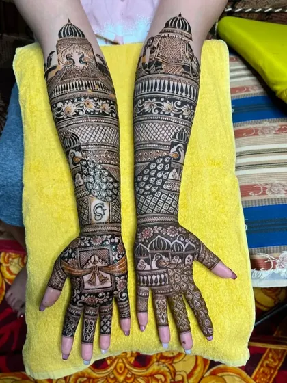 A full view of the peacock and initial design on both hands.