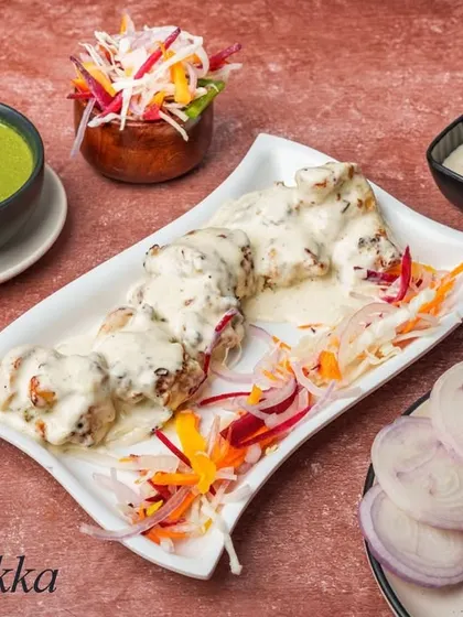 Malai Tikka is a rich and creamy kebab made with boneless chicken pieces marinated in cheese, cream, and mild spices. It's grilled until tender and has a melt-in-your-mouth texture.