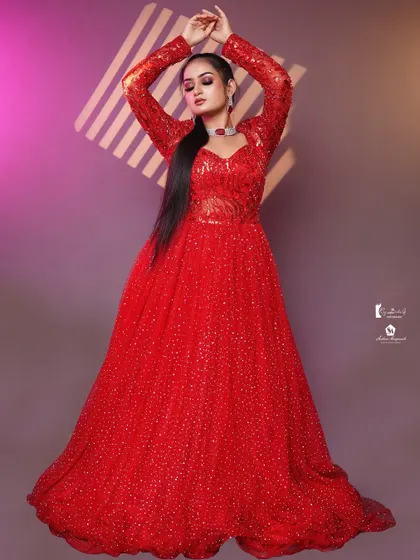 The full-length view shows the grandeur of the red sequined gown, perfect for a reception or red carpet event.