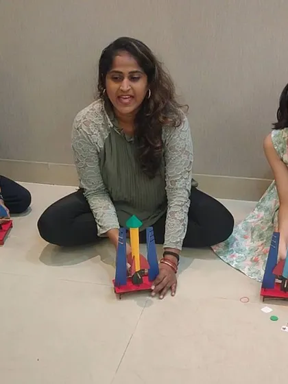 A birthday party that's out of this world! An instructor helps young explorers prepare their rockets for launch, making sure everyone is ready for the big moment.