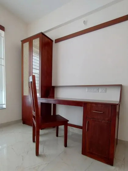 The complete home office set, including the desk, chair, and a tall cabinet with cane webbing on the doors for a touch of texture.