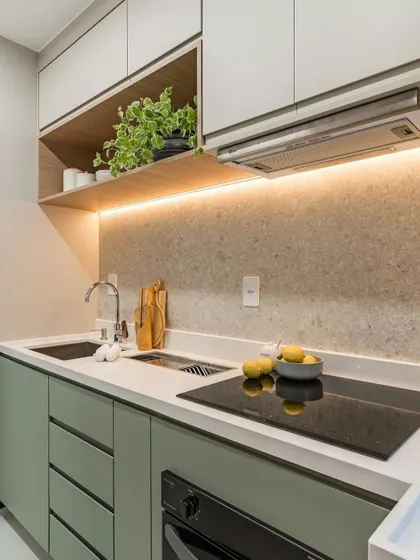 A close-up render of a kitchen corner, showing the detail in the under-cabinet lighting, the texture of the backsplash, and the placement of the induction hob.