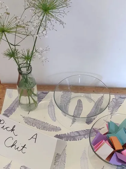"Pick a chit." A simple invitation to begin your journey. Each parent chooses an activity to start with, mirroring the freedom of choice that is fundamental to a child's day in a Montessori environment.