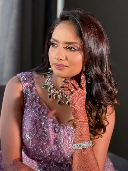 A classic pose showing the intricate details of her henna and the elegant makeup.