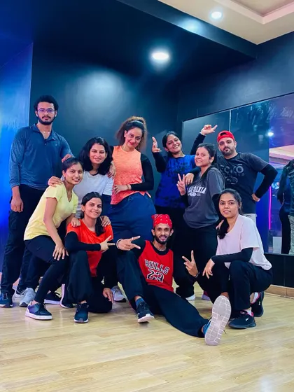 The 8-9 PM Bollywood class posing with their instructor.