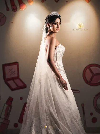 A full-length portrait of the bride in her beautiful strapless gown, complete with a long, flowing veil. This is a classic and timeless bridal look available for rent.